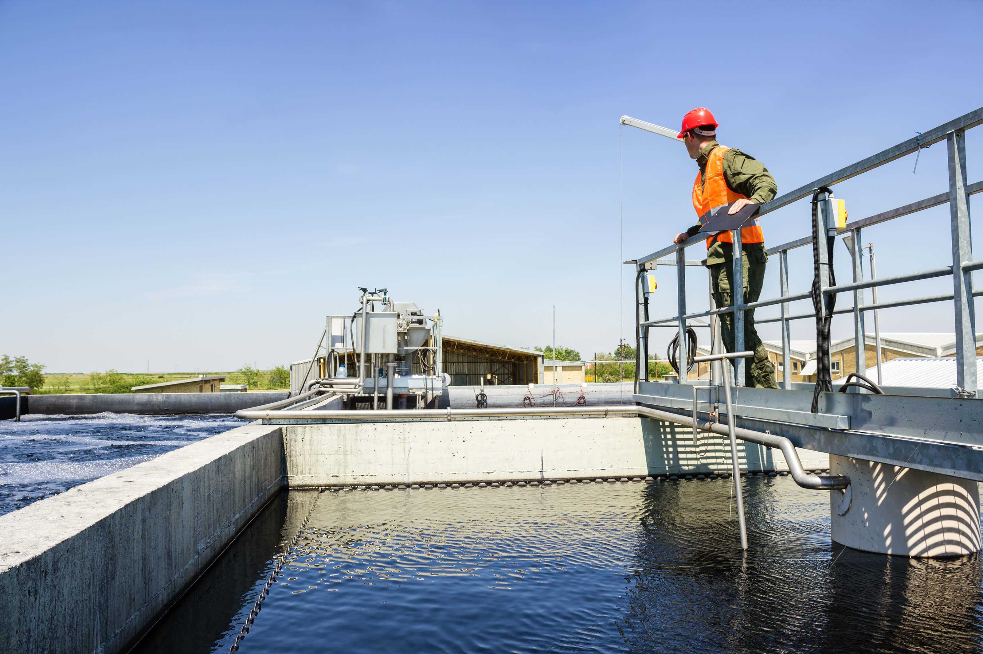 Engineer Overlooking Water Treatment Plant